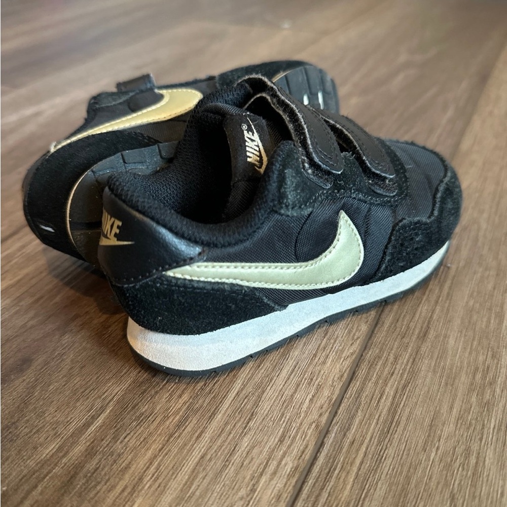 Nike Black and Gold Sneakers with Iconic Swoosh